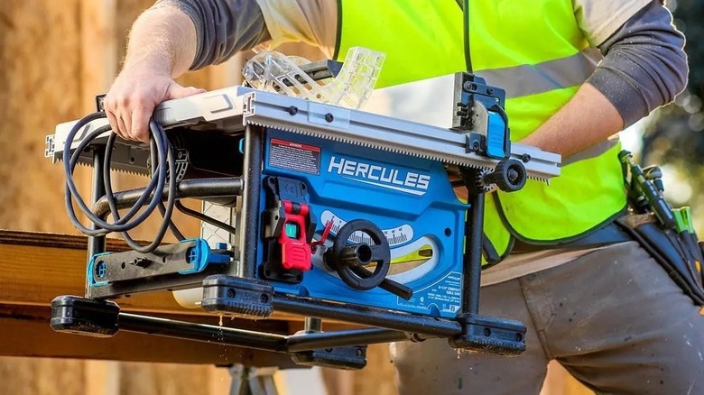 Person carrying a portable table saw