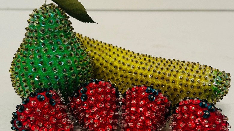 Vintage beaded green pear, yellow banana, and some red apples.