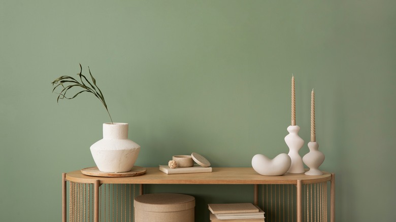 Green wall with pine table