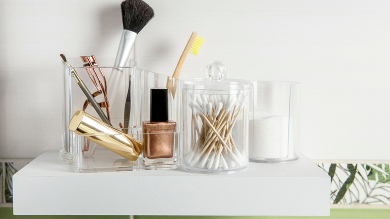 bathroom supplies on white shelf