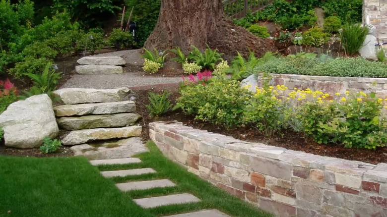 informal terraced garden beds using natural stone and stone slab steps