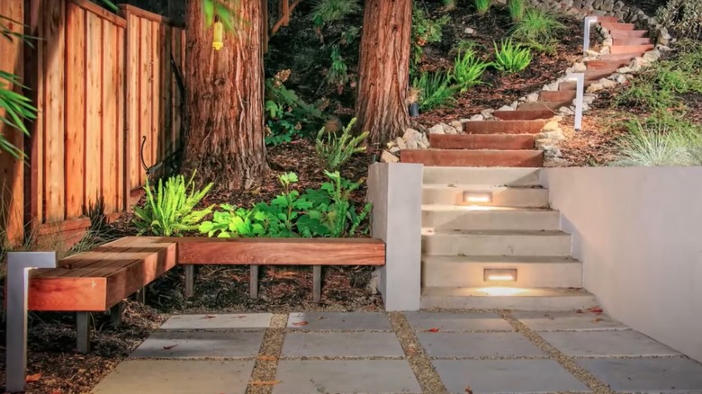 two types of stairs, leading to a formal landing with a built-in wooden bench