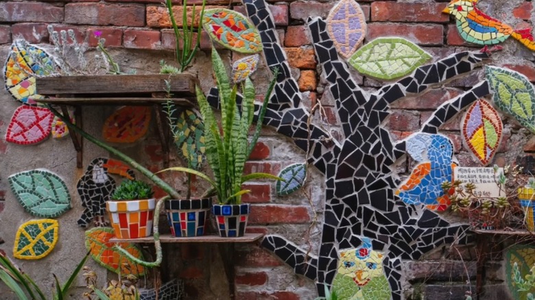 retaining wall decorated with a multi-color mosaic tree
