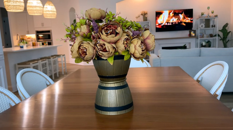 Vase centerpiece made of two planters filled with yellow and red blooms