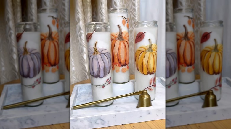 White candles in jars decorated with fall stickers
