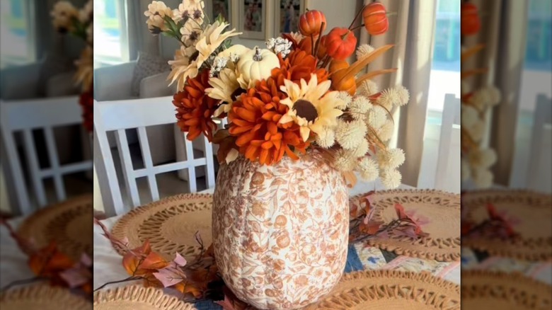 Decoupaged craft pumpkin used as a vase for centerpiece