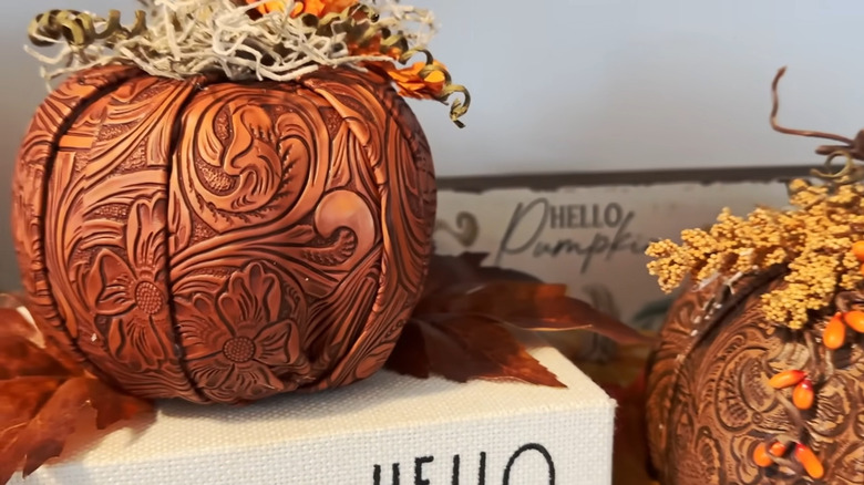 Leather embossed pumpkin decor next to a sign that says hello pumpkin