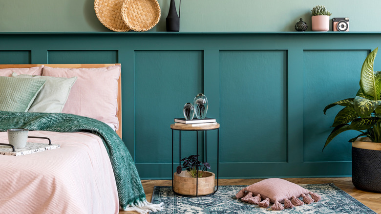 Teal baseboards pink bedding bedroom