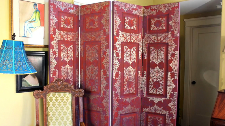 painted and stenciled room dividers can hide an eyesore in an otherwise empty corner