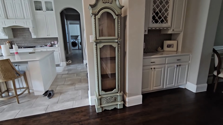 a gutted and refurbished grandfather clock makes a slim curio cabinet for almost any corner in the home
