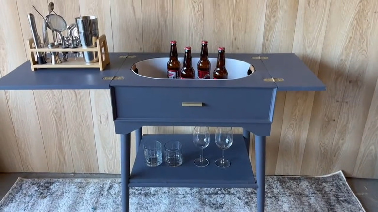 an old sewing cabinet can be transformed into a portable bar cart
