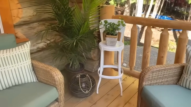 an old highchair can be upcycled as a plant stand for an empty corner on your porch