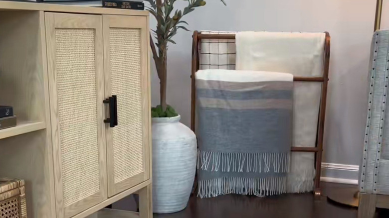 a quilt stand in the corner offers instant comfort and charm