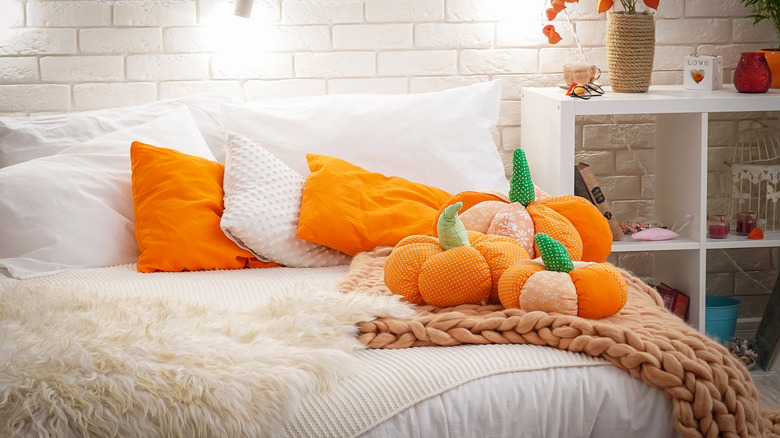 fall throw pillows on a bed