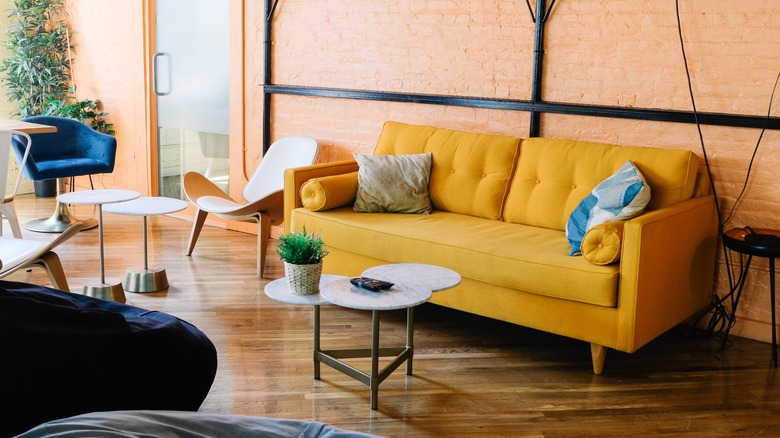 Yellow couch industrial apartment