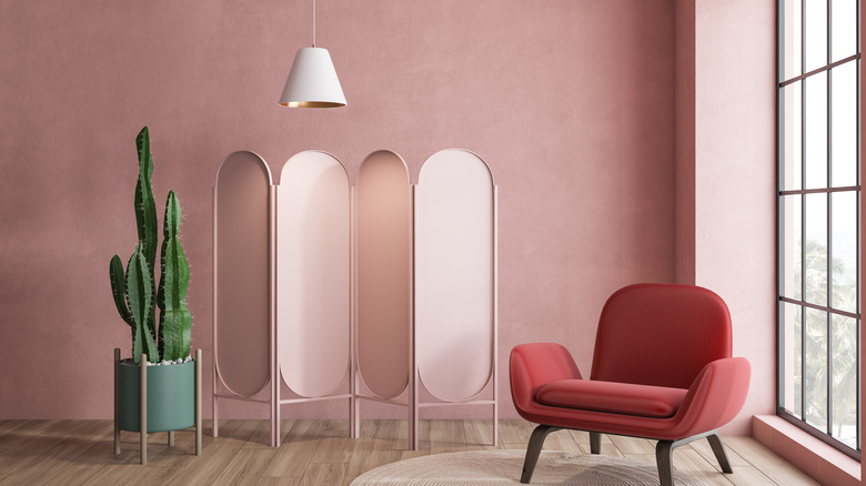 millennial pink wall with chair