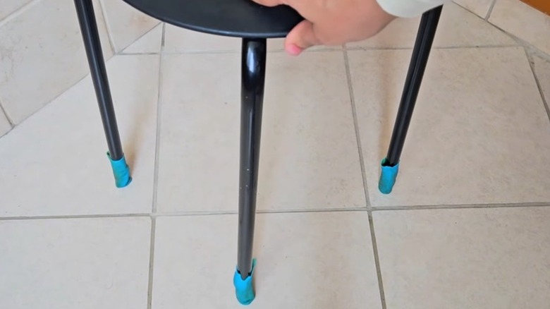 Furniture legs covered with blue rubber glove tips