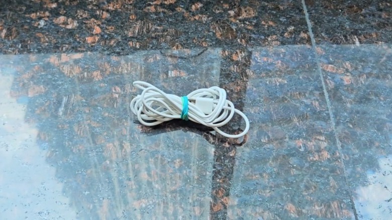 white charger on counter with blue band to keep wrapped