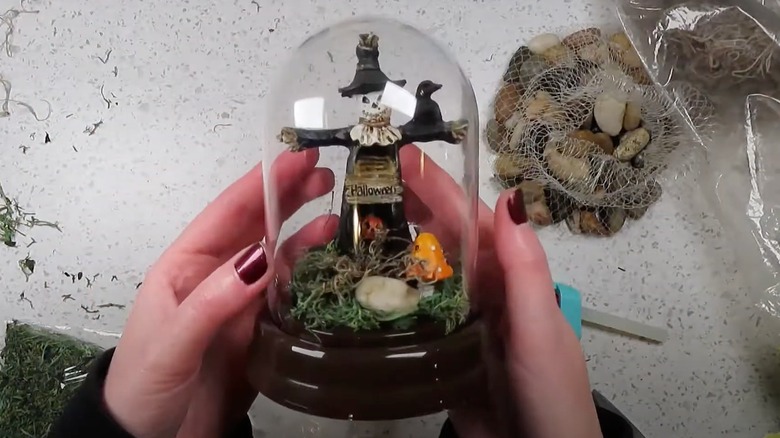 Tiny scarecrow in a glass cloche