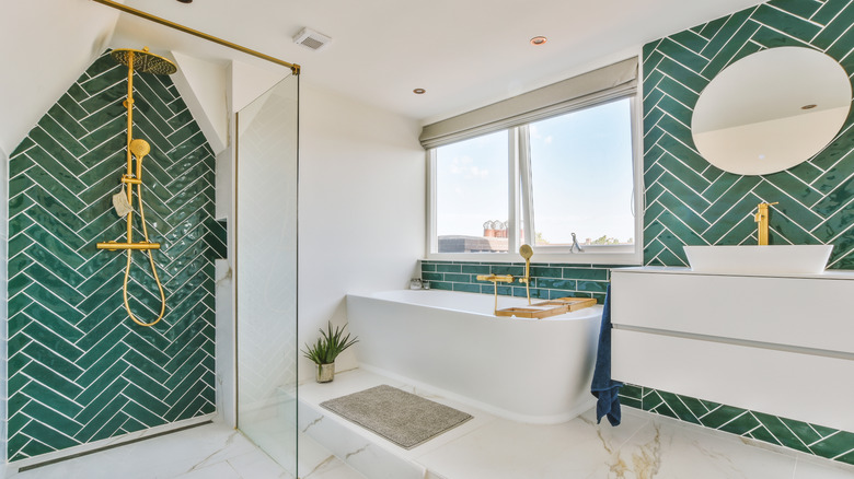 Gold bathroom fixtures with green tiles