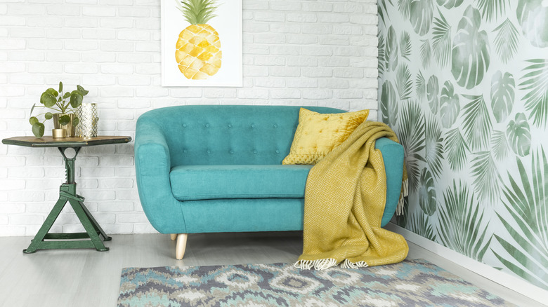 Living room with botanical wallpaper and geometric-print rug