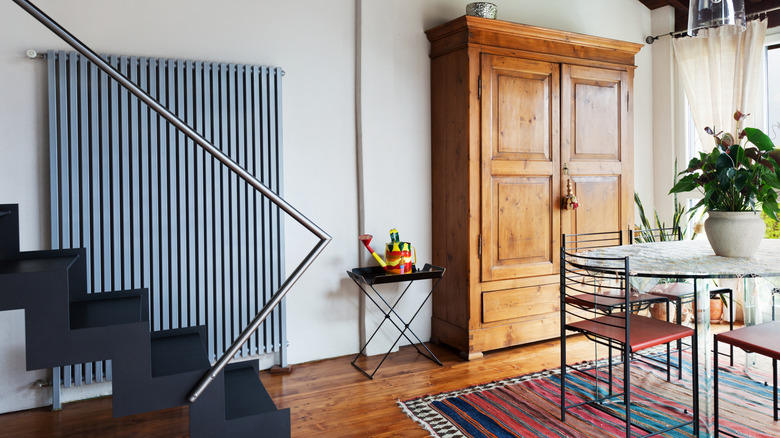 Modern stairs, dining table, and chairs with vintage armoire