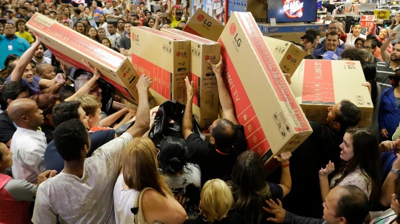 Crowd of people holding TVs