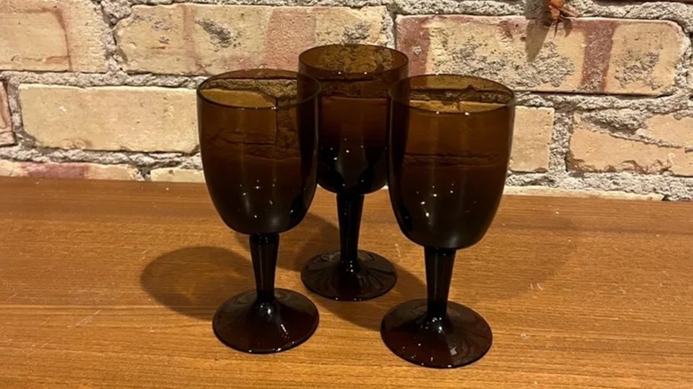 1960s Gorham Reizart brown stemware on a wood surface