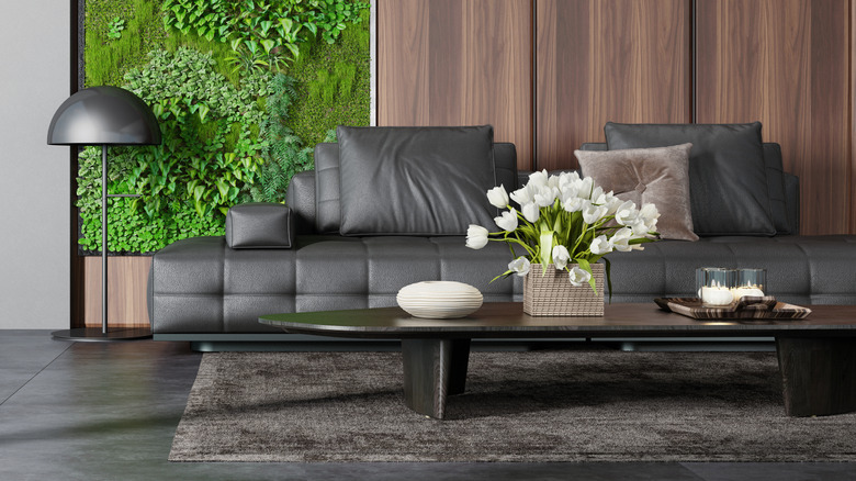 A living room with a black leather sofa