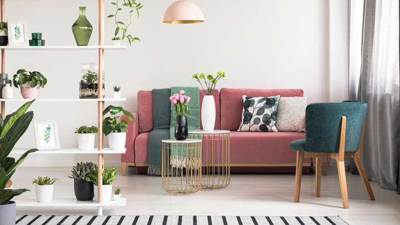 A pink sofa sits in a contemporary-designed living room