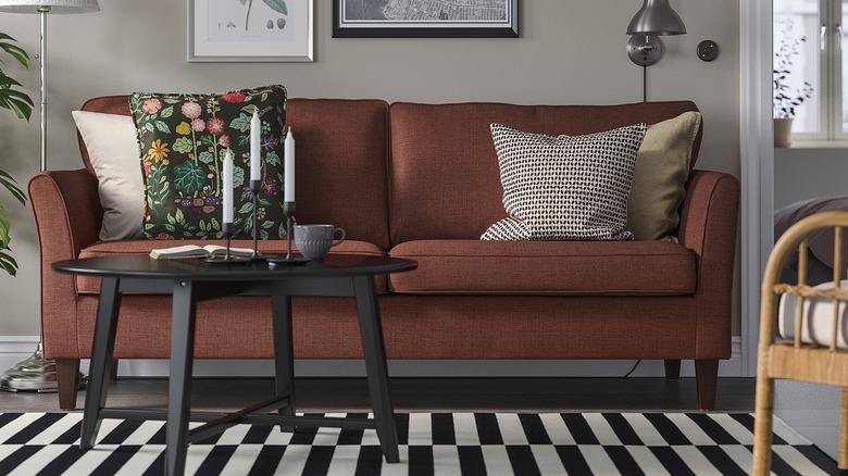 Deep red sofa with cushions in a modern home