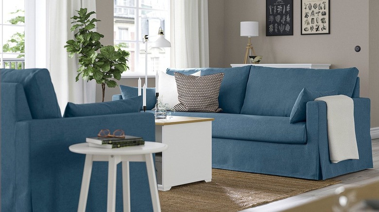 A deep blue sofa in a light and airy living room