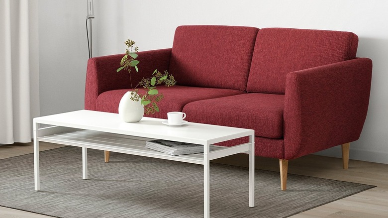 Red sofa in a modern home with a white coffee table