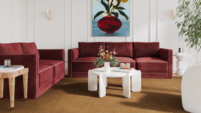 A maroon red velvet couch with contrast piping from Wayfair