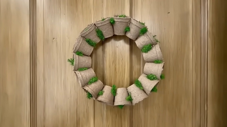 Homemade wreath made of mini potting plants and moss