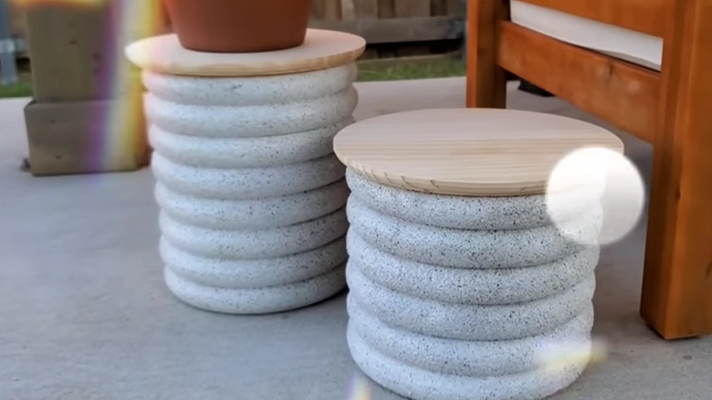 Two end tables made from foam rings and a trash can