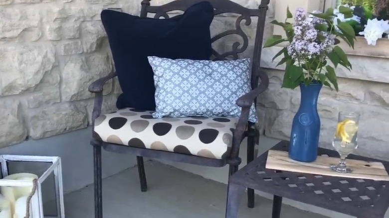 Blue and white patterned throw pillow made from placemats on an outdoor chair