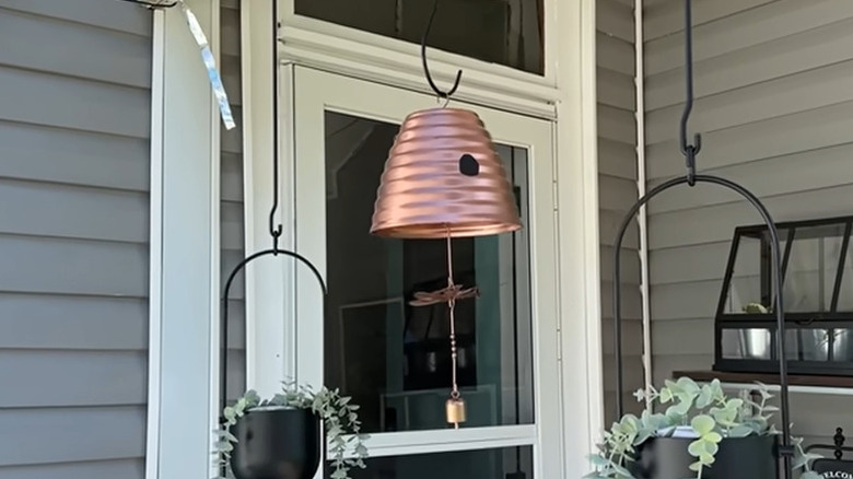 Flower pot turned upside down with wind chime hanging inside