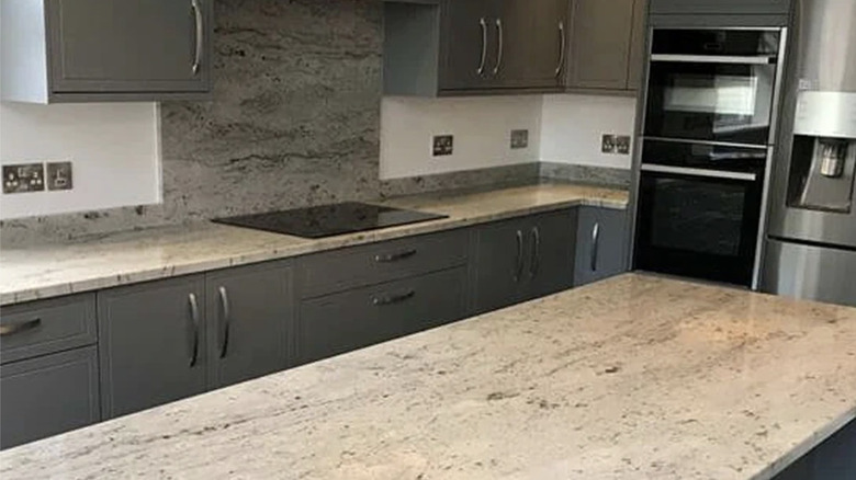 Modern kitchen with River White granite countertops