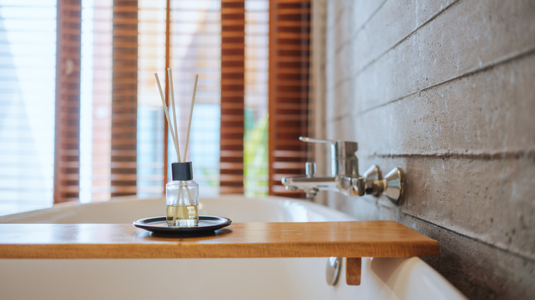 A fragrance diffuser on a bath tray.