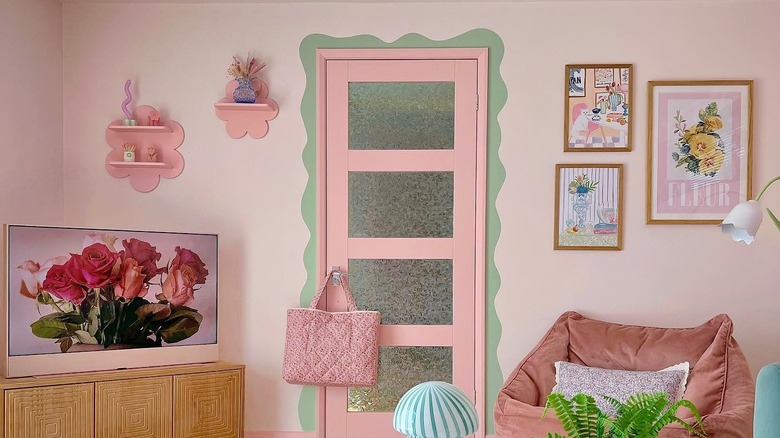 pink room with painted door and door border