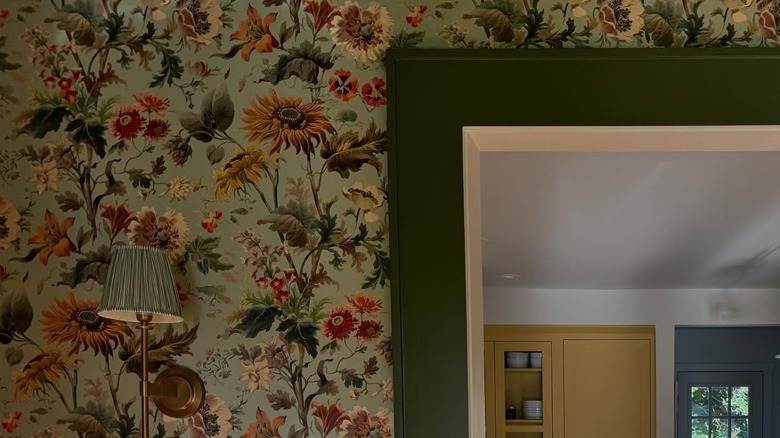 green painted trim with wallpaper