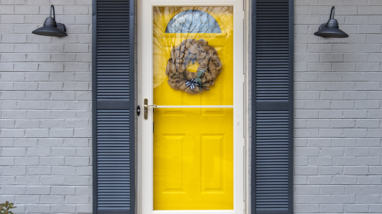 Yellow door with black shutters