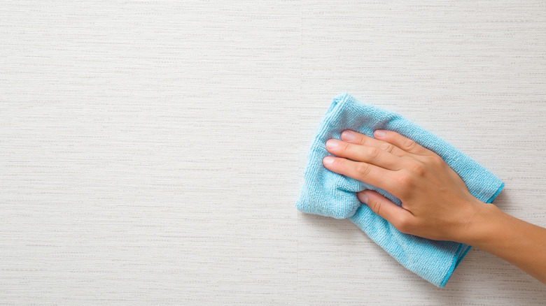 Wiping wallpaper with cloth