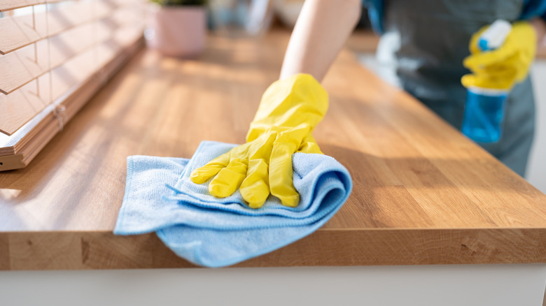 Wiping down wooden counter