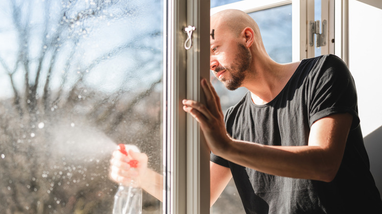 Man spraying window