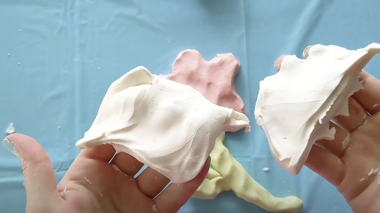 A person holding cloud dough