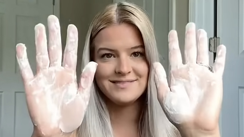 Young woman using cornstarch for dry shampoo