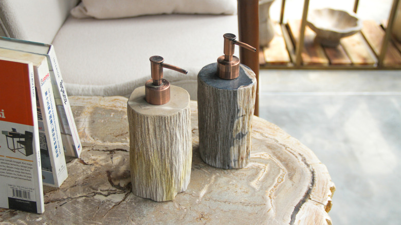 Pretty wood soap pumps on wood stool