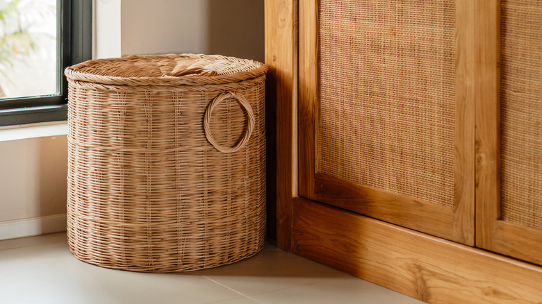 Basket in room beside wooden cabinet